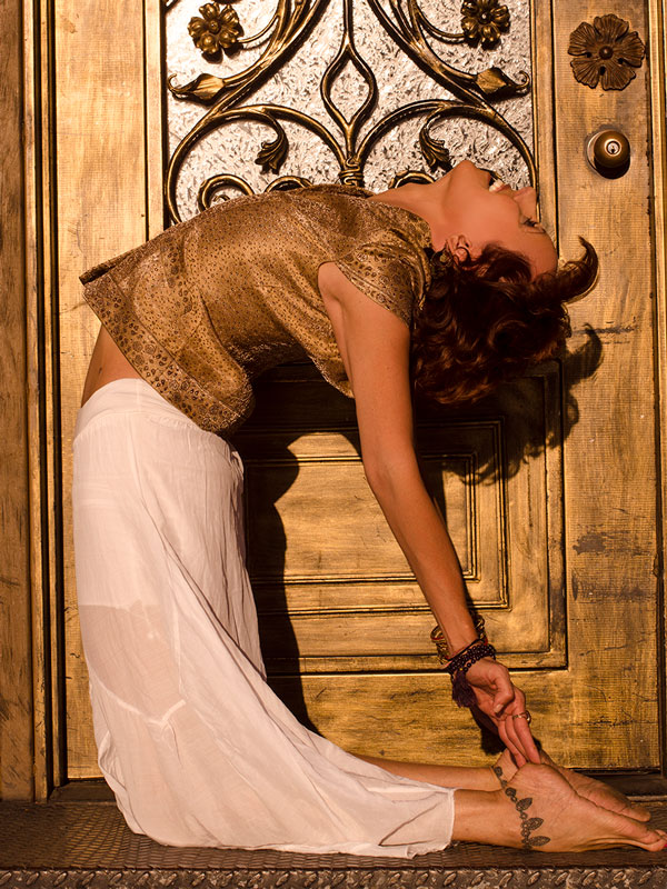 Yoga backbend in front of gold door