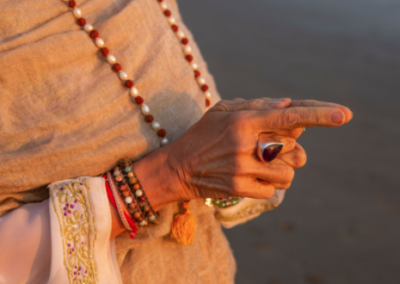 Jeannes hands and fingers pointing in meditation on beach
