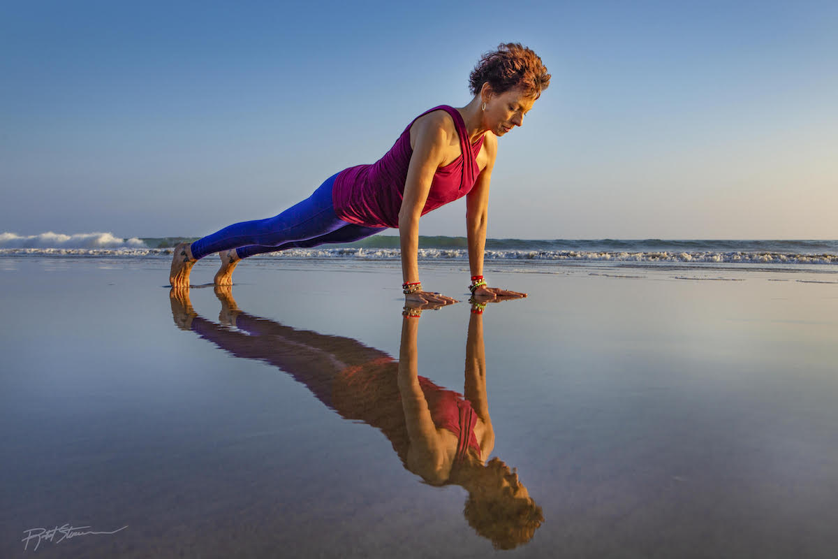 Jeanne on the beach on yoga pose