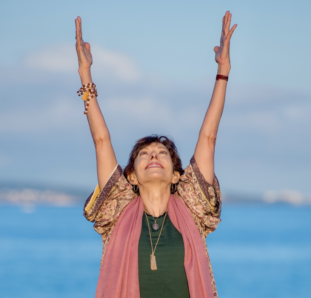 Jeanne with arms stretched to sky